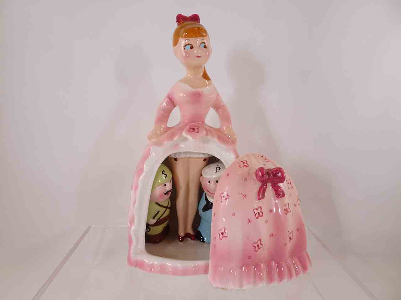 Army and Navy guys hiding beneath lady's dress salt and pepper shakers - pink version