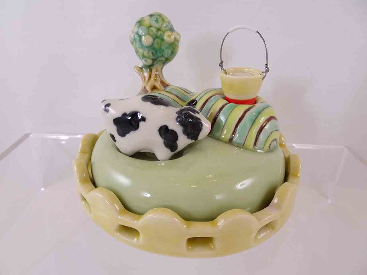 Chandra Debus cow in field with bucket salt and pepper shakers