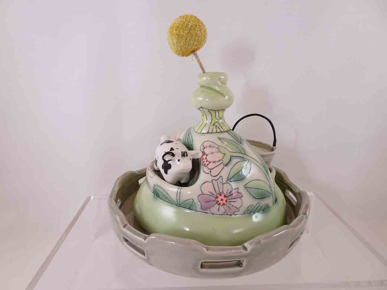 Chandra Debus cow in field with bucket salt and pepper shakers