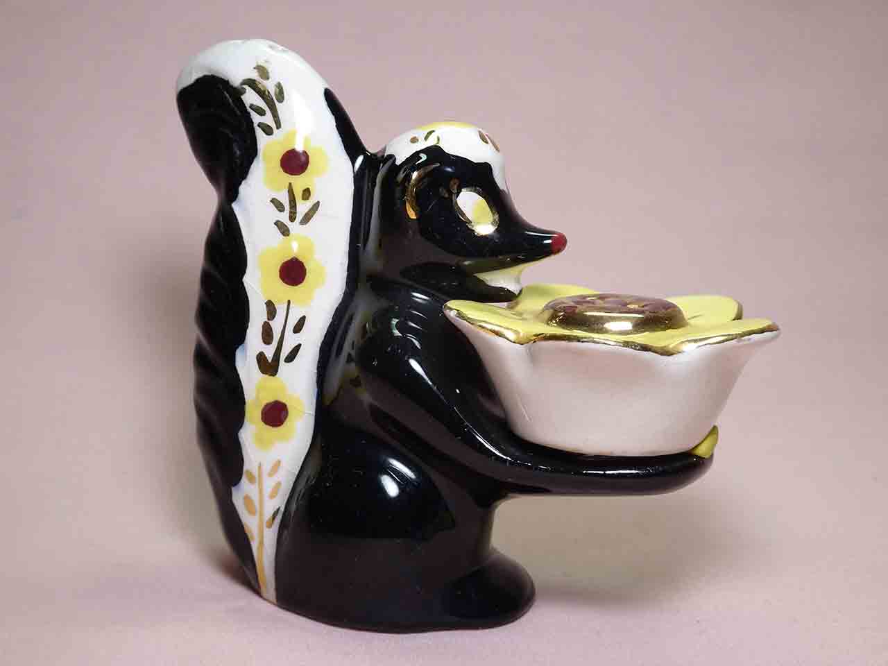 Poinsettia Studios California salt and pepper shakers - skunk holding flower