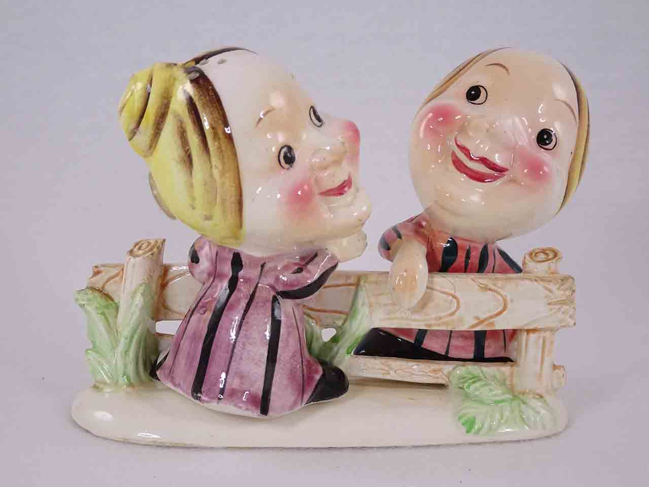 Neighbors at fence salt and pepper shakers