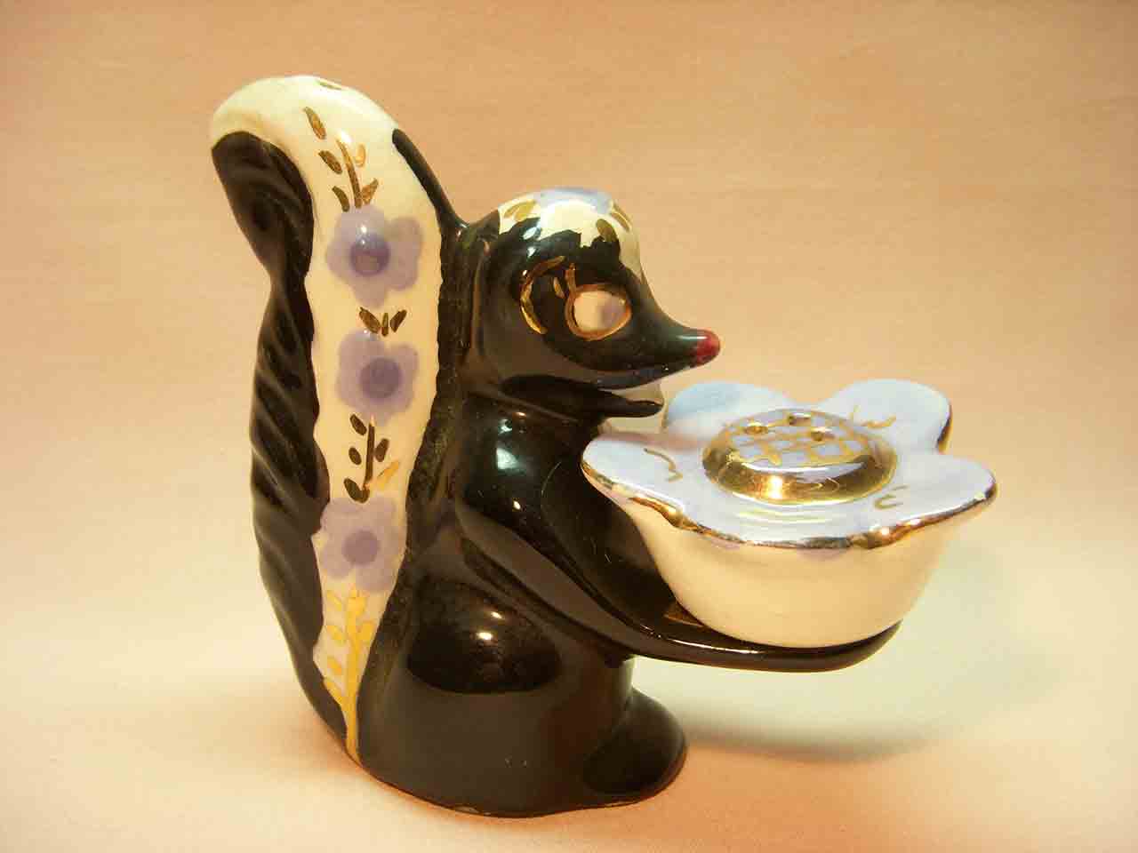 Poinsettia Studios California salt and pepper shakers - skunk holding flower